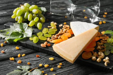 Olgun üzüm ve ahşap masa üzerinde kadehlerin aperatifler