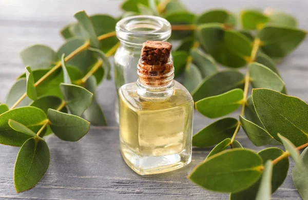 Bottles Essential Oil Eucalyptus Branches Wooden Table — Stock Photo, Image