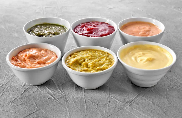 Different Tasty Sauces Bowls Grey Background — Stock Photo, Image