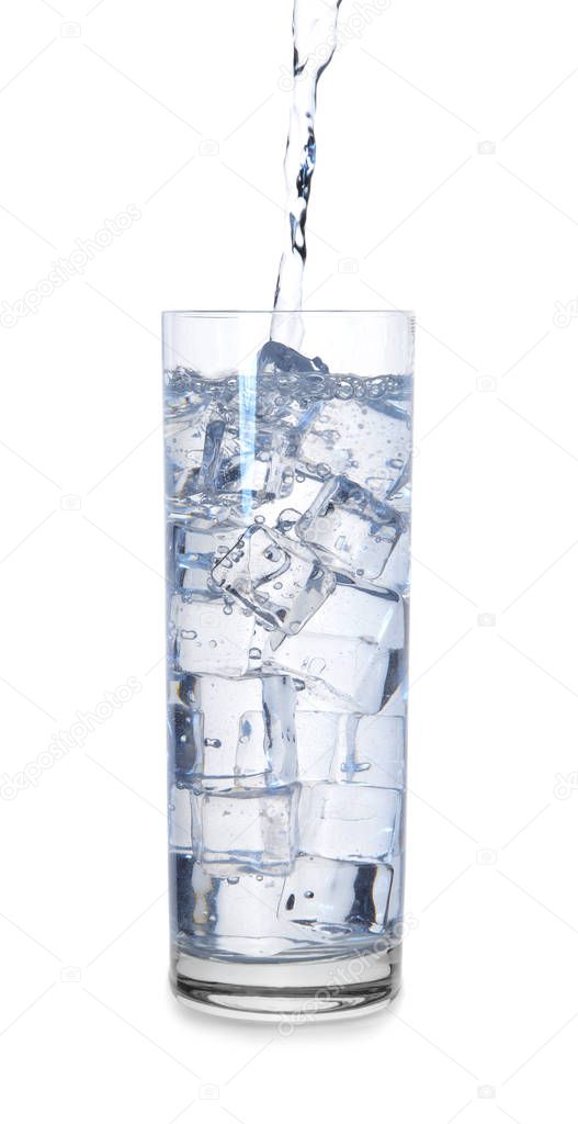 Pouring of water in glass with ice on white background