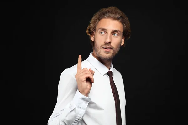 Handsome Businessman Raised Index Finger Black Background — Stock Photo, Image