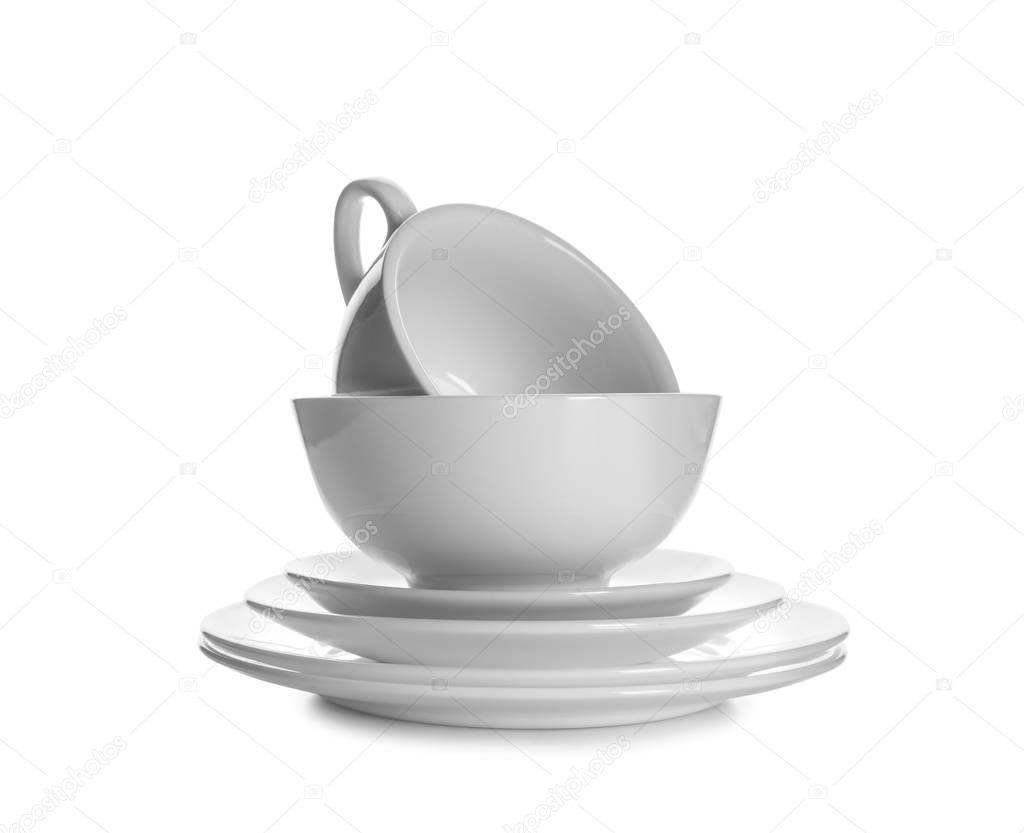 Set of clean tableware on white background