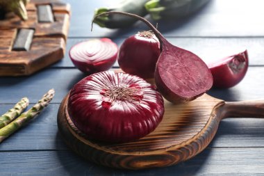 Olgun kırmızı soğan ile ahşap tahta üzerinde kesme pancar