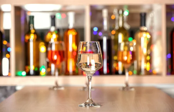 Glass of tasty wine on bar counter