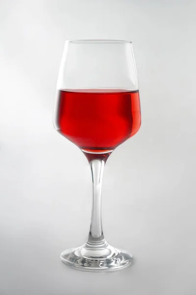 Glass of tasty wine on white background