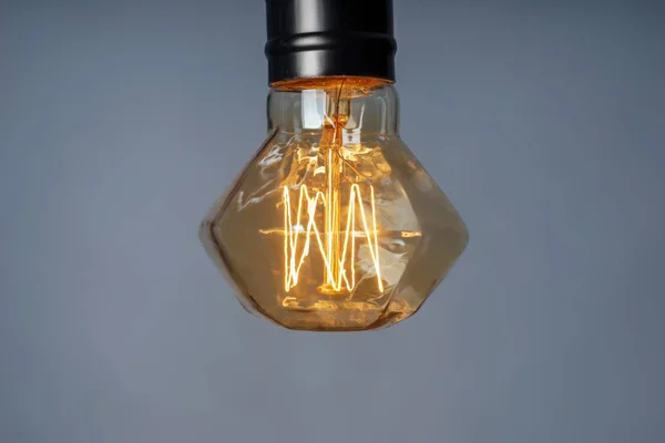 Retro light bulb on grey background