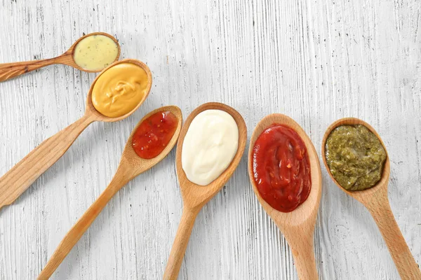 Spoons Tasty Sauces White Wooden Table — Stock Photo, Image