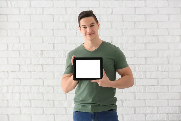 Young Man Tablet Computer White Brick Wall — Stock Photo, Image