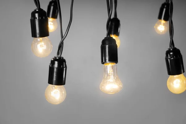 Glowing Light Bulbs Grey Background — Stock Photo, Image