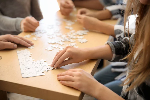 Group People Assembling Puzzle Wooden Table — Stock Photo, Image
