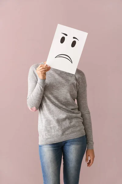 Young Woman Hiding Face Sheet Paper Drawn Emoticon Color Background — Stock Photo, Image