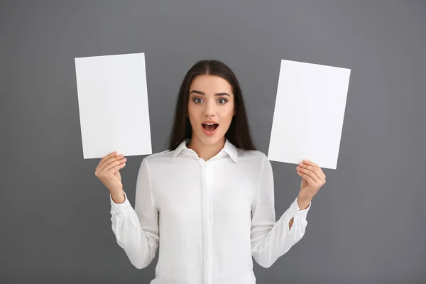 Emotional Young Woman Blank Sheets Paper Grey Background — Stock Photo, Image