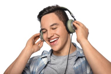 Genç adam beyaz arka planda müzik dinliyor.