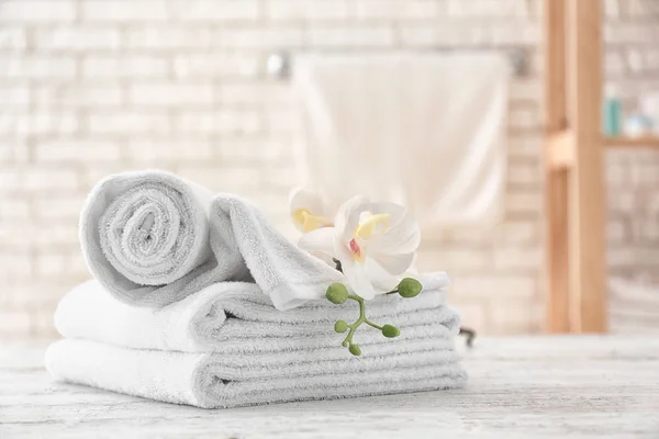 Towels with flowers on light table
