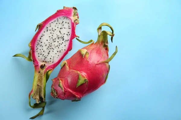 Tasty dragon fruits on color background