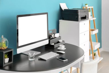 Çalışma alanı bilgisayarda Office renk duvarının yakınında tablo ile