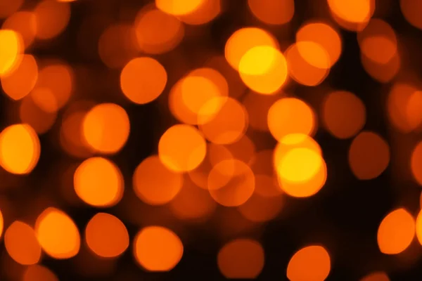 Blurred view of beautiful lights on dark background