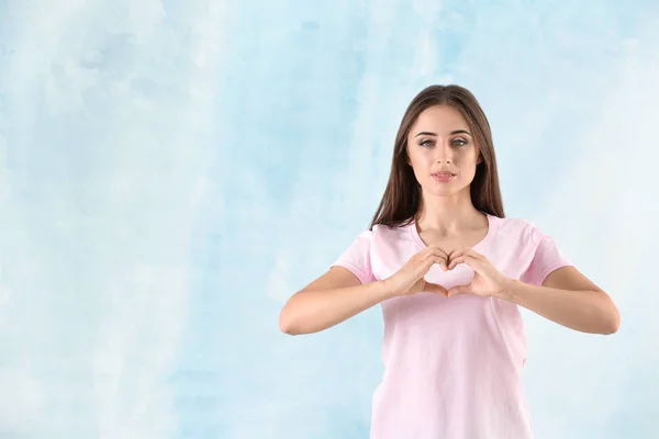 Young Woman Stylish Shirt Making Heart Her Hands Light Background — Stock Photo, Image