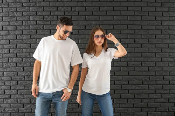 Young Man Woman Stylish Shirts Dark Brick Wall — Stock Photo, Image
