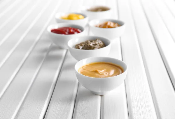 Different Tasty Sauces Bowls White Wooden Table — Stock Photo, Image