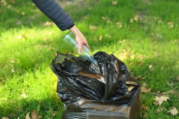 Woman gathering trash in park