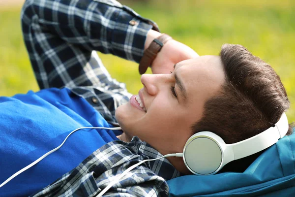 Young Man Listening Music While Lying Green Grass Park — Stock Photo, Image