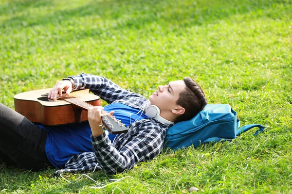 Young Man Playing Guitar While Lying Green Grass Park — Stock Photo, Image