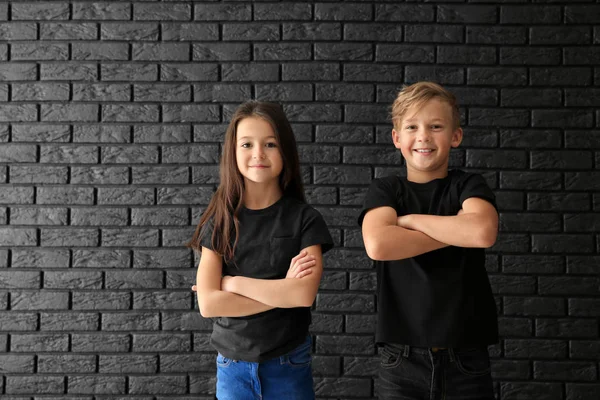 Cute Children Shirts Dark Brick Wall — Stock Photo, Image