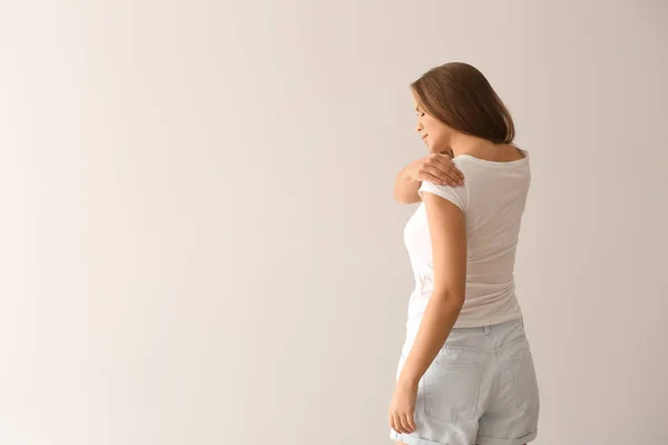 Young Woman Suffering Pain Shoulder Light Background — Stock Photo, Image