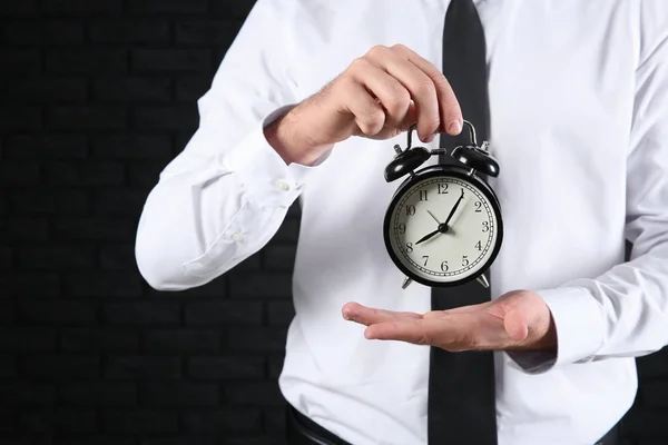 Businessman Alarm Clock Dark Background Closeup — Stock Photo, Image