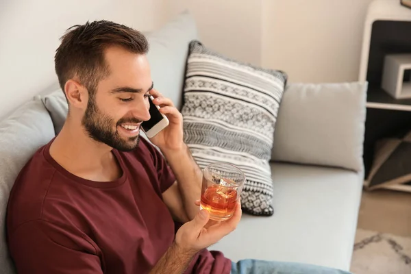 Young Man Drinking Whiskey While Talking Phone Home — Stock Photo, Image