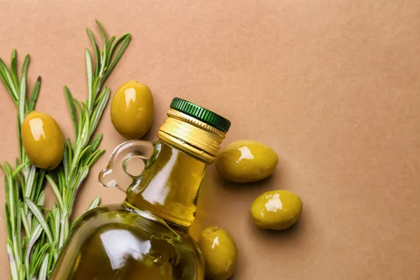 Bottle of olive oil on color background