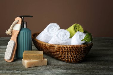 Hasır sepet haddelenmiş yumuşak havlu ve banyo aksesuarları ahşap tablo