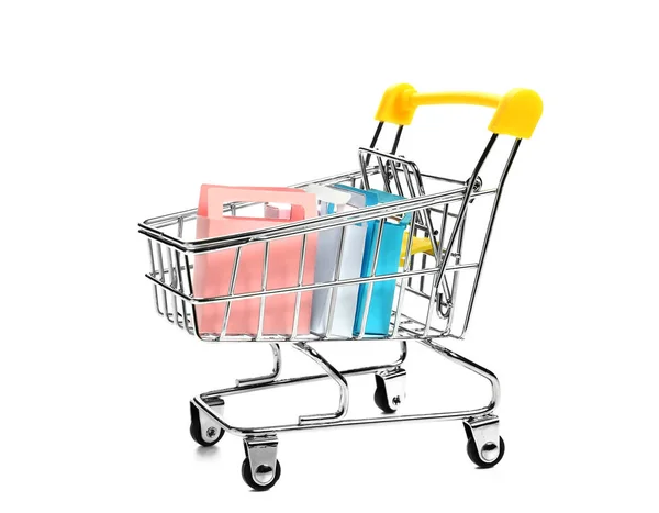 小さな袋とボックスが白い背景の上ショッピングカート — ストック写真