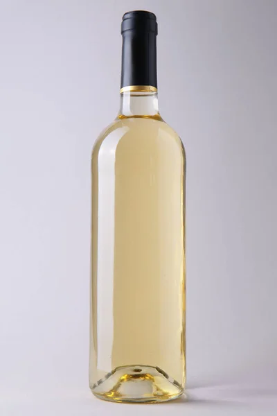 Bottle of white wine on grey background