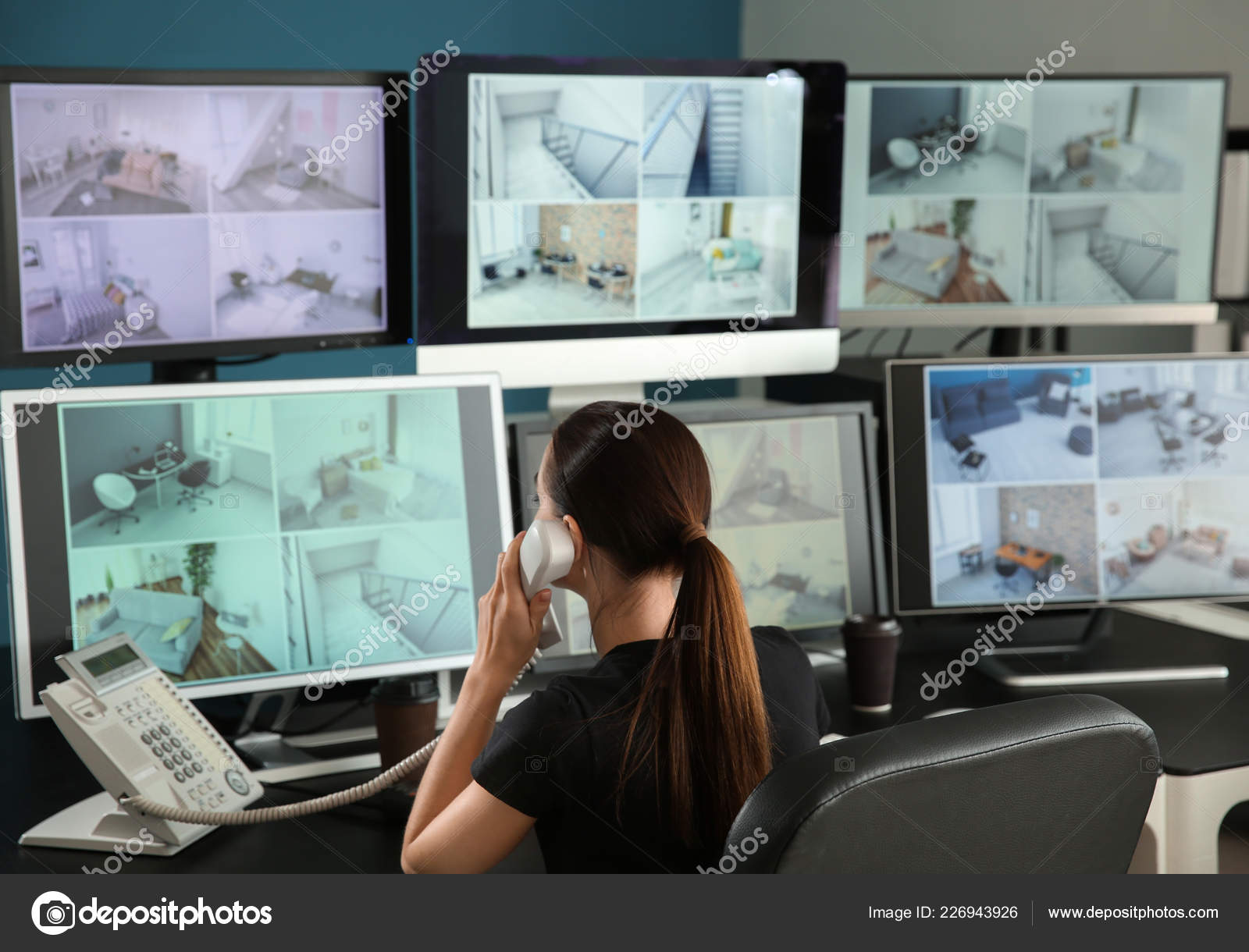 Security Guard Talking Phone While Monitoring Modern Cctv