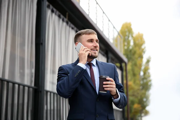 Young Businessman Cup Coffee Talking Phone Outdoors — Stock Photo, Image