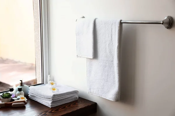 Clean towels and cosmetics in bathroom