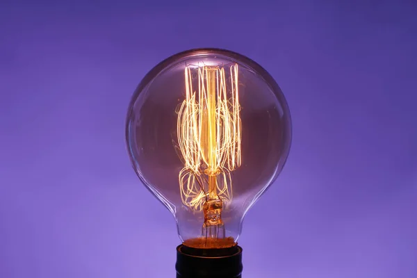 Glowing Old Light Bulb Color Background — Stock Photo, Image