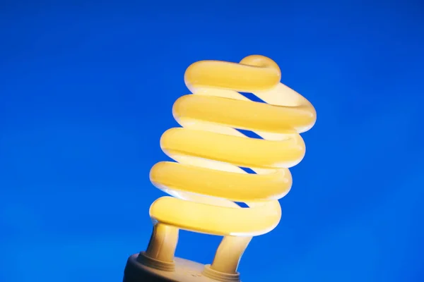 Glowing Spiral Light Bulb Color Background — Stock Photo, Image