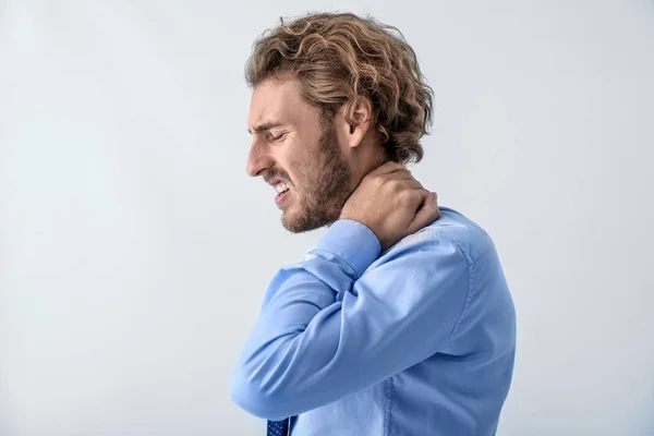 Young Man Suffering Neck Pain Light Background — Stock Photo, Image