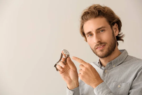 Young Man Pointing His Watch Light Background — Stock Photo, Image