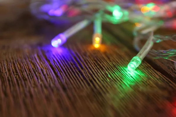 Glowing Christmas Lights Wooden Table Closeup — Stock Photo, Image