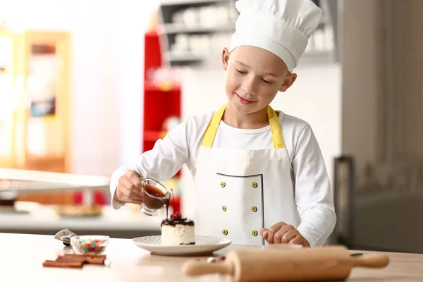 Cute Little Chef Pouring Tasty Dessert Chocolate Sauce Kitchen — Stock Photo, Image