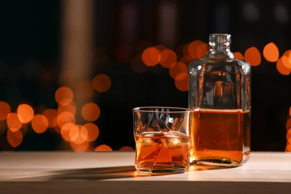 Glass Bottle Whiskey Wooden Table Blurred Lights — Stock Photo, Image