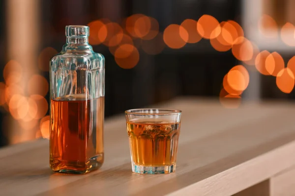 Glass Bottle Whiskey Wooden Table Blurred Lights — Stock Photo, Image