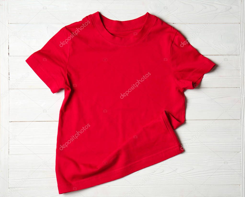 Child t-shirt on white wooden background