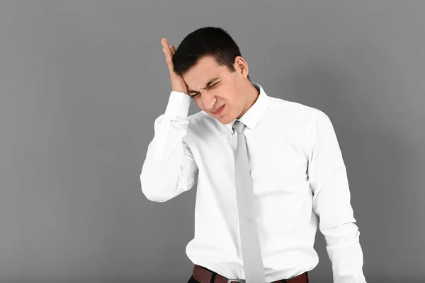 Young Man Suffering Headache Grey Background — Stock Photo, Image