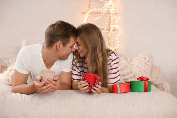 Loving Young Couple Drinking Hot Chocolate While Lying Bed Room — Stock Photo, Image