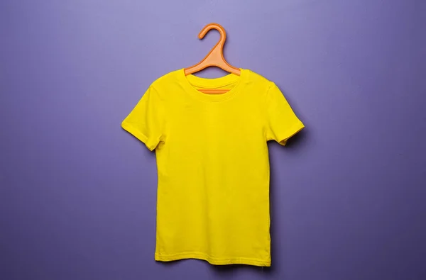 Child t-shirt with hanger on color background